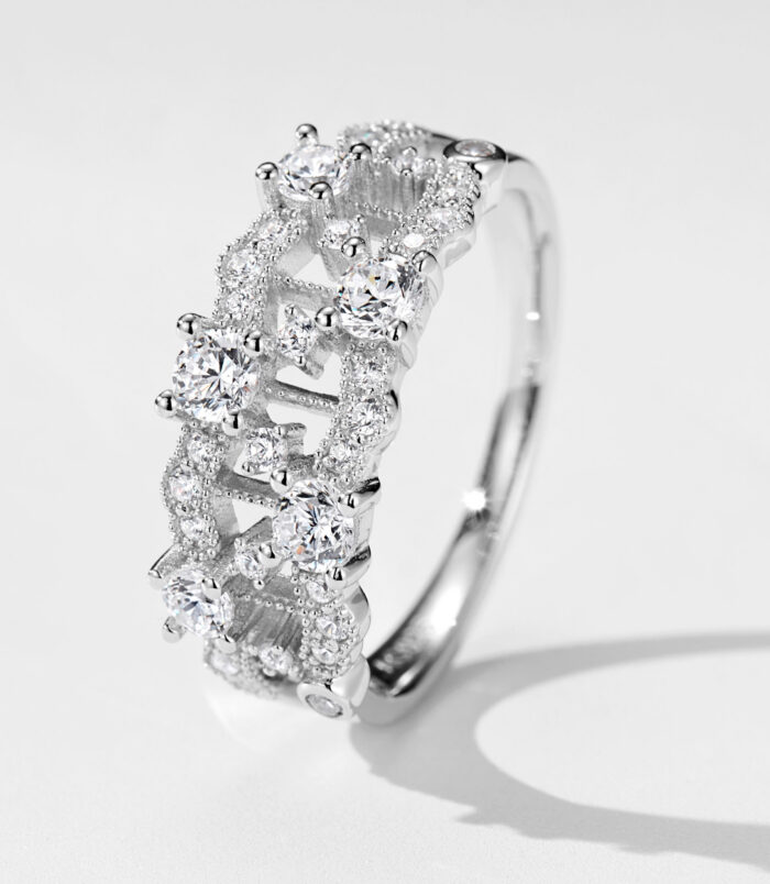 Stunning cluster-style sterling silver ring featuring multiple round brilliant-cut white cubic zirconia stones set in an intricate openwork band, creating a sparkling and luxurious look perfect for adding a touch of glamour to any outfit.
