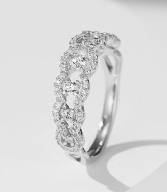 Elegant twisted infinity sterling silver ring featuring a continuous row of round brilliant-cut white cubic zirconia stones set in an intricate twisted band, creating a sparkling and sophisticated look perfect for adding a touch of glamour to any outfit.