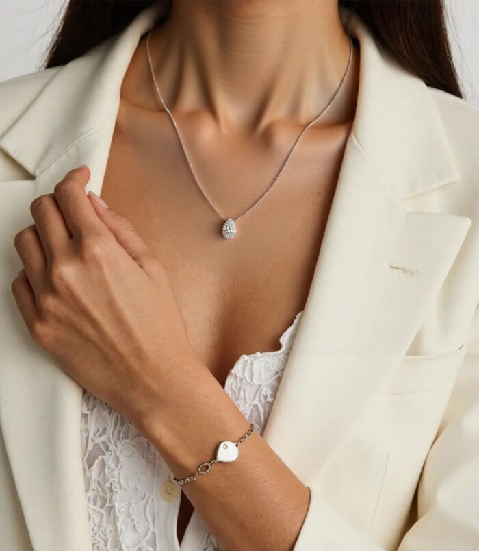 Sterling Silver Solitaire Halo Pear-cut Zirconia Pendant Necklace displayed by model