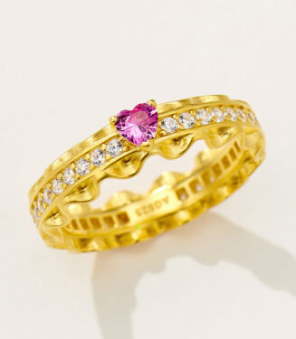 Romantic gold-plated sterling silver eternity ring featuring a central heart-shaped pink cubic zirconia stone flanked by round brilliant-cut white cubic zirconia stones set in a scalloped band, creating a feminine and elegant look perfect for expressing love and affection.