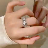 Romantic Openwork Floral Design Sterling Silver Band Ring worn on a model's finger