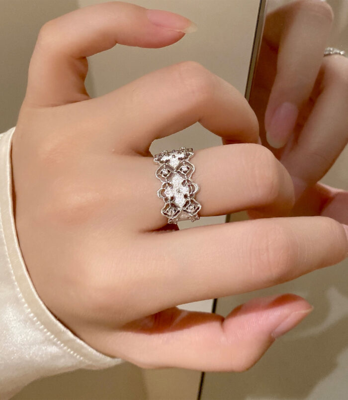 Romantic Openwork Floral Design Sterling Silver Band Ring worn on a model's finger