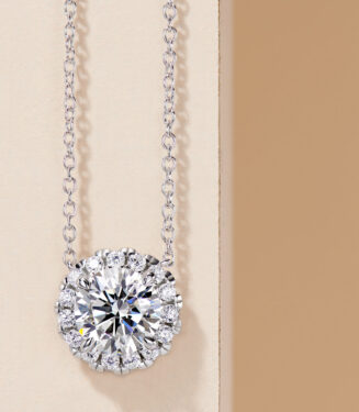 Exquisite sterling silver solitaire necklace, showcasing a large round brilliant-cut white cubic zirconia stone in a halo setting, surrounded by smaller round brilliant-cut white cubic zirconia stones, paired with a classic cable chain, creating a timeless and elegant look perfect for adding a touch of sophistication to any outfit.