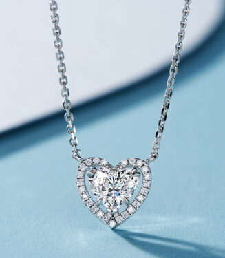 Romantic sterling silver heart-shaped pendant necklace, featuring a large heart-shaped brilliant-cut white cubic zirconia stone as the centerpiece, surrounded by a halo of small round brilliant-cut white cubic zirconia stones, paired with a classic cable chain, creating a timeless and elegant look perfect for expressing love and adding a touch of romance to any outfit.