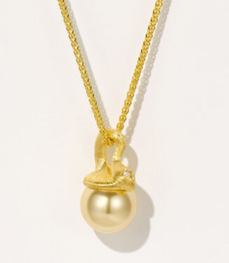 Stylish gold-plated sterling silver necklace featuring a single large round golden South Sea pearl as the centerpiece, secured with a unique hook-shaped gold-plated sterling silver clasp adorned with a small round brilliant-cut white cubic zirconia stone, paired with a classic cable chain, creating a modern and sophisticated look perfect for adding a touch of luxury to any outfit.