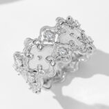 Intricate vintage-inspired sterling silver band ring featuring an openwork floral design with delicate milgrain detailing, round brilliant-cut cubic zirconia accents, and a textured brushed silver center, creating a romantic and sophisticated look perfect for adding a touch of vintage charm to any outfit.
