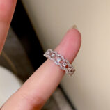 hand held close-up of Sparkling Twisted Infinity Sterling Silver Ring