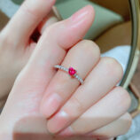 hand held close-up of Enchanting Heart-Shaped Simulated Ruby Sterling Silver Ring