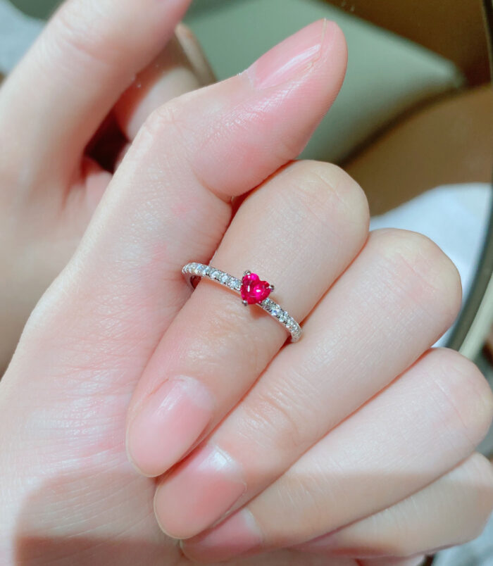 hand held close-up of Enchanting Heart-Shaped Simulated Ruby Sterling Silver Ring