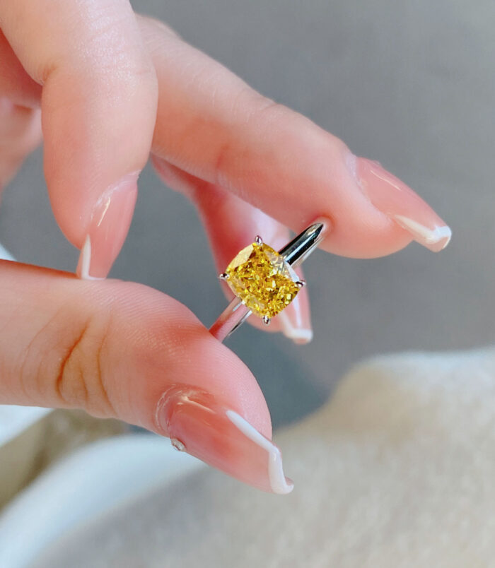 Cushion-Cut Yellow gemstone Sterling Silver Solitaire Ring handheld details hand held close-up of Cushion-Cut Yellow gemstone Sterling Silver Solitaire Ring