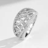 Stunning sterling silver band ring featuring an intricate criss-cross design adorned with sparkling round brilliant-cut cubic zirconia stones set in a pavé setting, creating a bold and glamorous look perfect for making a statement and adding a touch of luxury to any outfit.