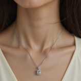 Sterling silver perfume bottle necklace worn around the model's neck