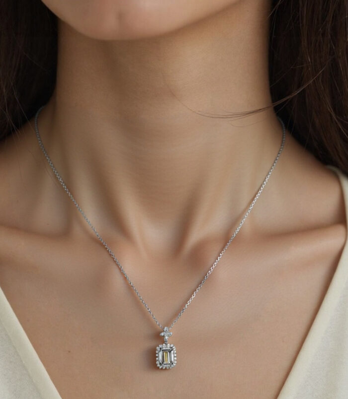 Sterling silver perfume bottle necklace worn around the model's neck