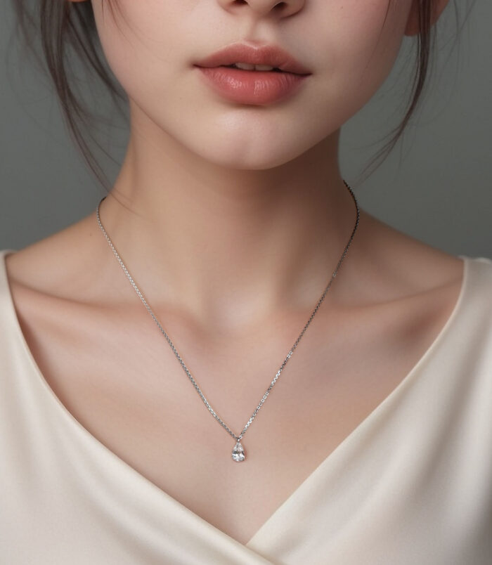 Sterling Silver Solitaire Pear-Shaped Zirconia Pendant Necklace worn on model's neck