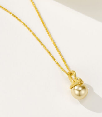 side view close-up of Sterling silver snake-shaped gold pearl necklace