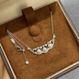 Fan-shaped pearl lace necklace displayed in jewelry box