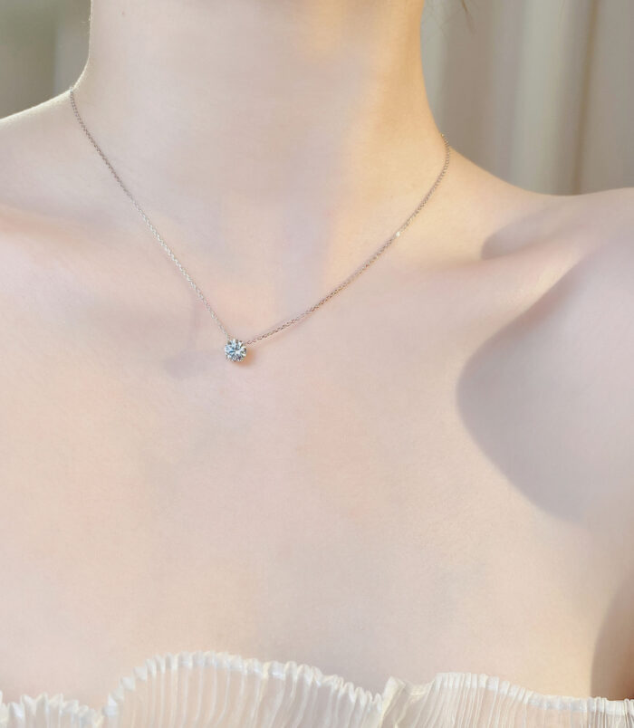 Sleek Sterling Silver Solitaire zirconia Necklace worn on model's neck