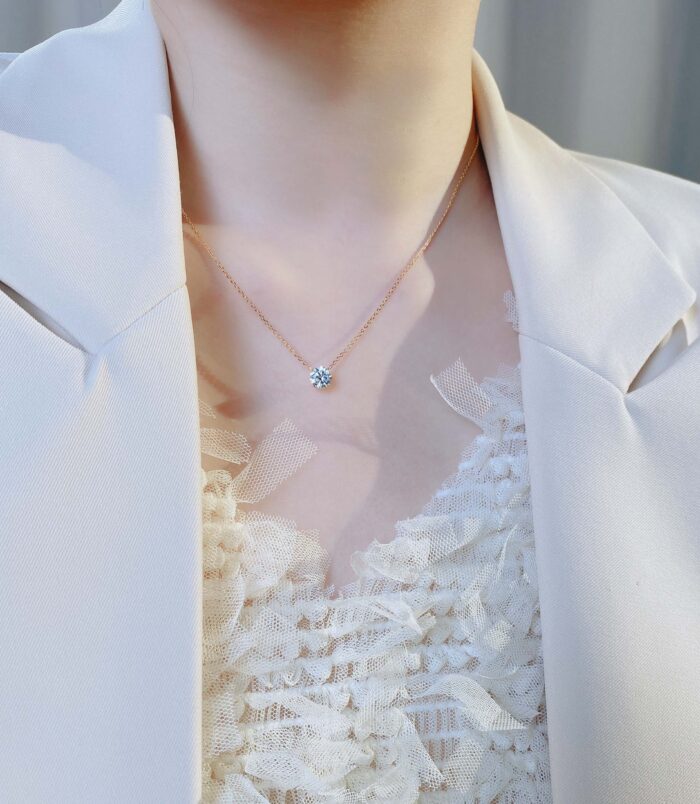 Sleek Sterling Silver Solitaire zirconia Necklace display on model's neck