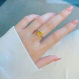Cushion-Cut Yellow gemstone Sterling Silver Solitaire Ring worn on model's finger