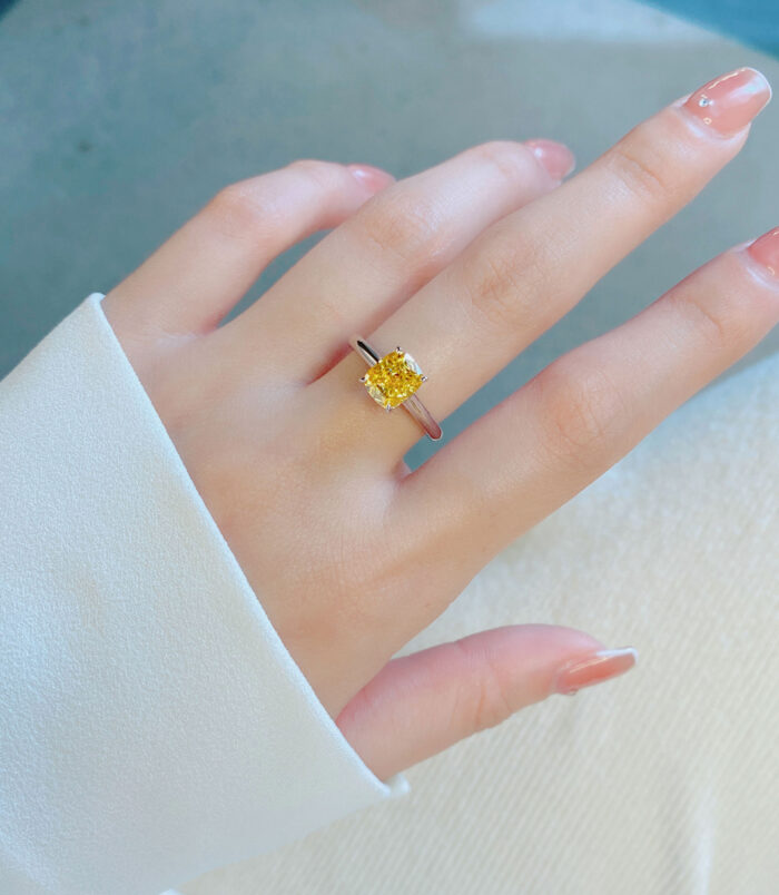 Cushion-Cut Yellow gemstone Sterling Silver Solitaire Ring wearing effect Cushion-Cut Yellow gemstone Sterling Silver Solitaire Ring worn on model's finger