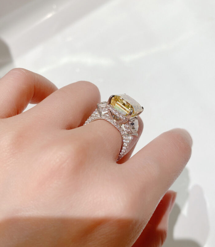 back view close-up of Luxury Yellow Emerald-Cut Three-Stone Sterling Silver Ring on model's finger