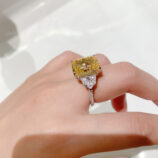 side view close-up of Luxury Yellow Emerald-Cut Three-Stone Sterling Silver Ring on model's finger