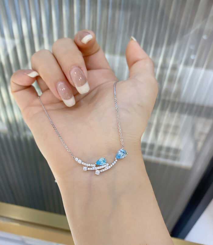 Sterling Silver Blue Zirconia Stones and Star Accents Necklace hand held details hand held close-up of Sterling Silver Blue Zirconia Stones and Star Accents Necklace