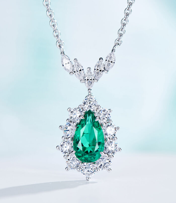 Dazzling Sterling Silver Necklace with Pear-Cut Green Cubic Zirconia Halo Pendant Exquisite sterling silver necklace featuring a large pear-cut green cubic zirconia stone at the center, surrounded by a halo of round brilliant-cut white cubic zirconia stones, topped with a decorative bail adorned with marquise-cut white cubic zirconia stones, creating a dazzling and sophisticated look perfect for adding a touch of elegance to any outfit.