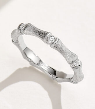 Unique bamboo-inspired sterling silver ring with textured segments and round brilliant-cut cubic zirconia accents, symbolizing resilience, growth, and prosperity, perfect for nature lovers and those who appreciate meaningful jewelry.