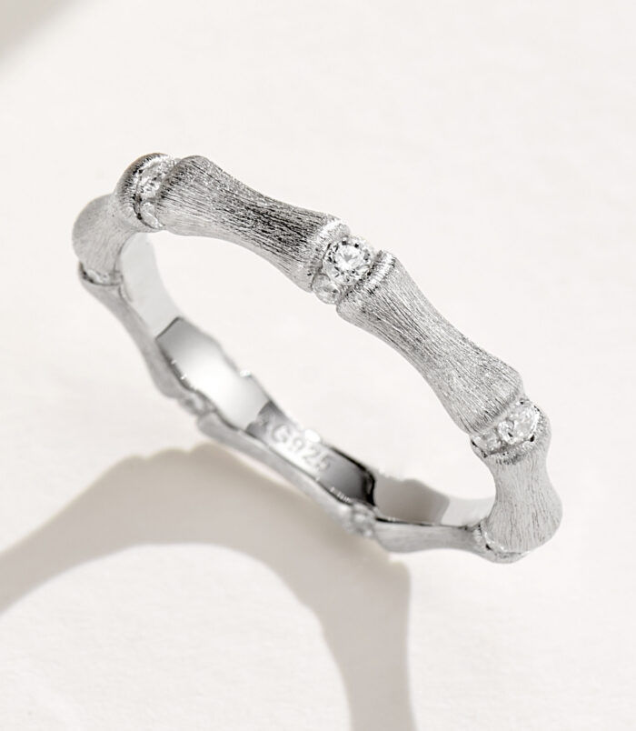 Unique bamboo-inspired sterling silver ring with textured segments and round brilliant-cut cubic zirconia accents, symbolizing resilience, growth, and prosperity, perfect for nature lovers and those who appreciate meaningful jewelry.