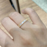gold plated Baguette-Cut Zirconia Sterling Silver Band Ring worn on a model's finger