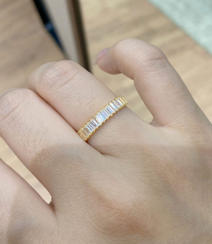 gold plated Baguette-Cut Zirconia Sterling Silver Band Ring worn on a model's finger