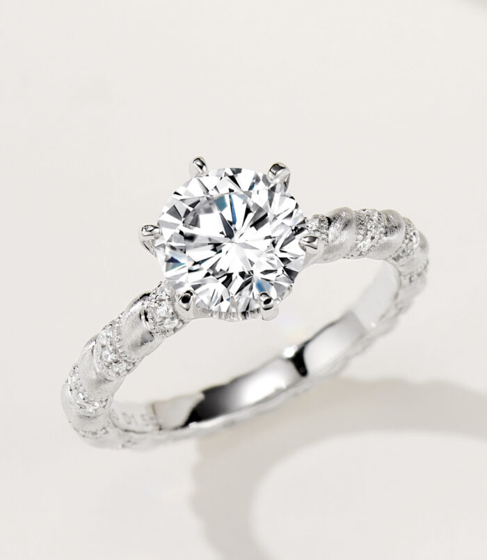 Nature-Inspired Bark-Textured Cubic Zirconia Sterling Silver Engagement Ring Rustic-inspired sterling silver engagement ring with a large round brilliant-cut cubic zirconia center stone in a four-prong setting, featuring a bark-textured band with pavé-set cubic zirconia accents for a nature-inspired and unique look.