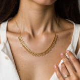 gold plated Sterling silver lace-trimmed necklace worn around model's neck