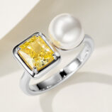 Modern two-stone open sterling silver ring featuring a large emerald-cut yellow cubic zirconia stone set in a bezel setting and a lustrous white pearl, creating a bold and contemporary look perfect for adding a touch of luxury to any outfit.