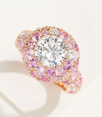 Stunning two-tone sterling silver ring featuring a large round brilliant-cut white cubic zirconia center stone, surrounded by a double halo of pink cubic zirconia stones, with pavé-set pink zircons along the rose gold-plated band for a romantic and glamorous look.