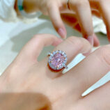 Glamorous Pink Gemstone Halo Sterling Silver Ring on a model's finger