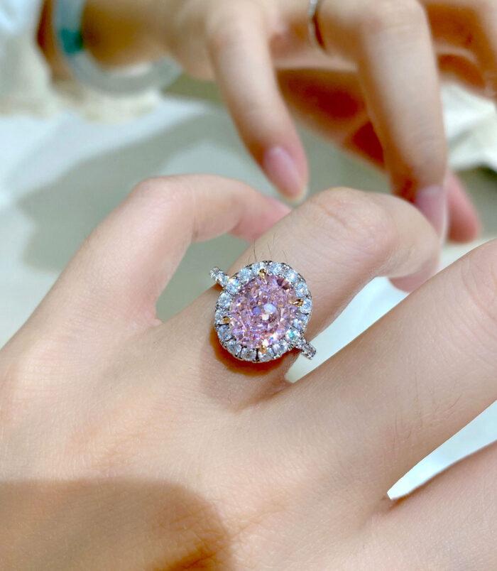 Glamorous Pink Gemstone Halo Sterling Silver Ring on a model's finger