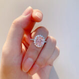 hand held close-up of Glamorous Pink Gemstone Halo Sterling Silver Ring