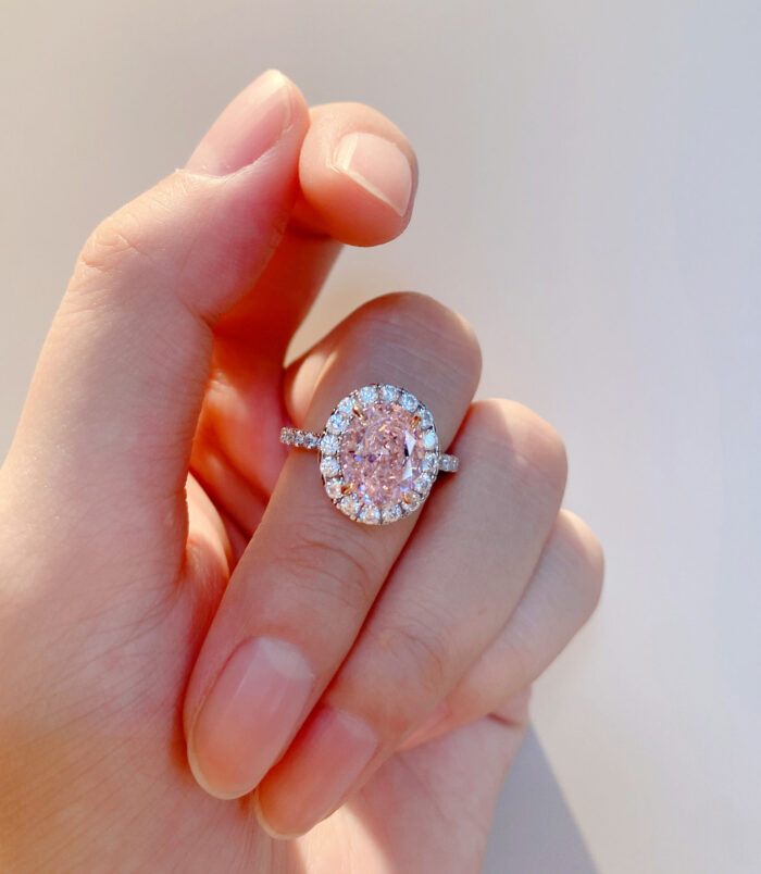 hand held close-up of Glamorous Pink Gemstone Halo Sterling Silver Ring