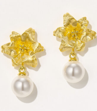 Sterling silver flower-shaped drop earrings with a white pearl pendant.