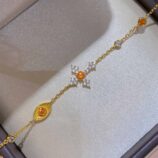 orange cross silver bracelet placed in jewelry box ，showcase real , unfiltered product