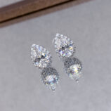 Sterling Silver Pear-Shaped Stud Earrings reflected beautifully on a mirror