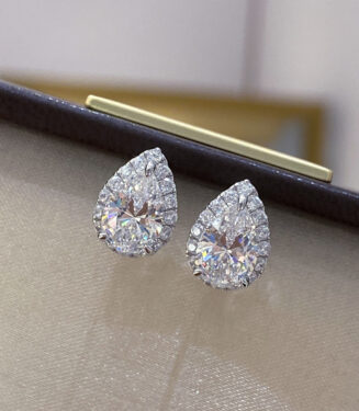 Sterling Silver Pear-Shaped Stud Earrings displayed in jewelry box