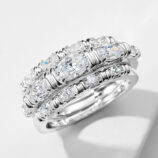 three 925 sterling silver stackable rings worn together, featuring a combination of a solitaire-style ring with a oval-cut cubic zirconia stone and a pavé-set band, and a sleek eternity band with oval cubic zirconia stones, creating a modern and elegant look.