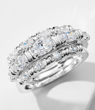 three 925 sterling silver stackable rings worn together, featuring a combination of a solitaire-style ring with a oval-cut cubic zirconia stone and a pavé-set band, and a sleek eternity band with oval cubic zirconia stones, creating a modern and elegant look.