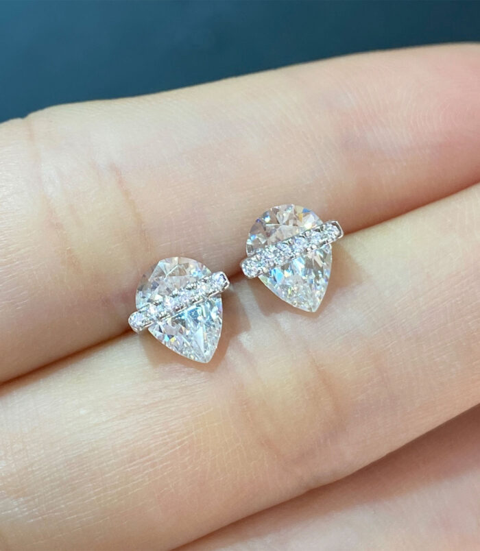 Sterling Silver Pear cut Cubic Zirconia Stud Earrings hand held details hand held close up of Sterling Silver Pear cut Cubic Zirconia Stud Earrings