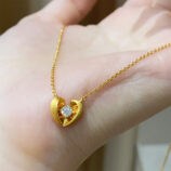 hand held close-up of gold plated 925 Sterling Silver Brushed Heart Necklace