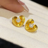 Sterling Silver Brushed Gold-Plated Heart Stud Earrings on a jewelry box