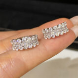 hand held close up of Sterling Silver Cubic Zirconia Huggie Hoop Earrings